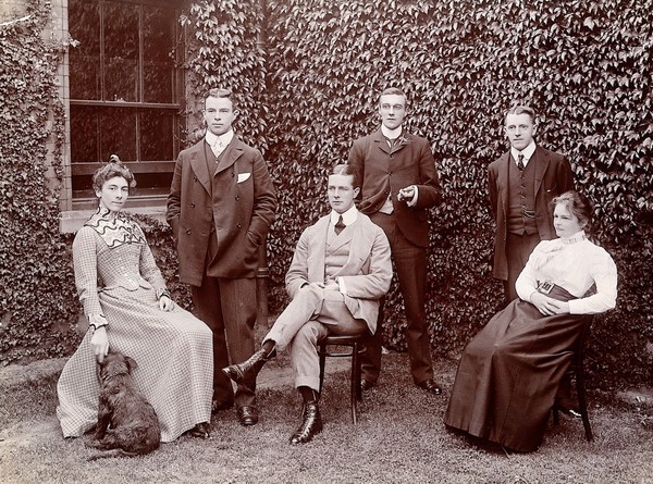 Claybury Asylum, Woodford, Essex: six members of staff, and a dog. Photograph by the London & County Photographic Co., [1893?].