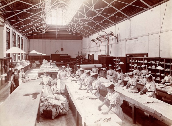 Claybury Asylum, Woodford, Essex: an ironing room. Photograph by the London & County Photographic Co., [1893?].