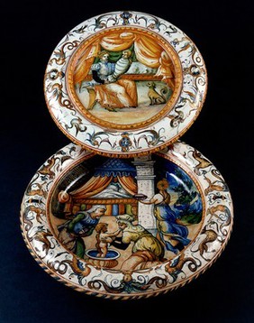 Two ceramic plates with childbirth scenes