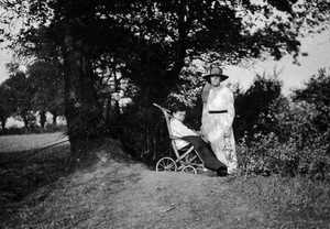 view A physically disabled boy sitting in a wheelchair. Photograph, ca. 1910/1925.