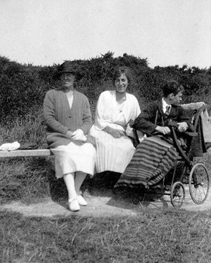 view A physically disabled boy sitting in a wheelchair. Photograph, ca. 1910/1925.