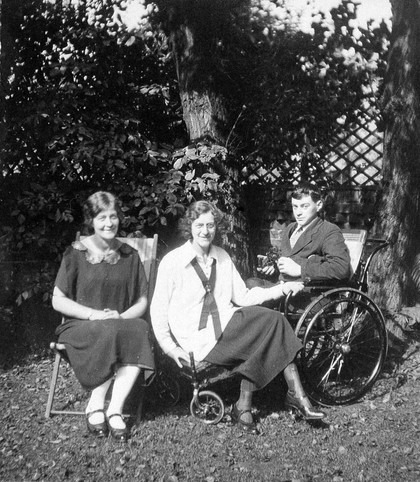 A physically disabled boy sitting in a wheelchair. Photograph, ca. 1910/1925.