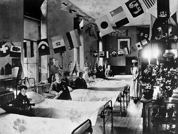 Hahnemann Hospital and Homœopathic Dispensaries, Liverpool: a ward, decorated with flags possibly for the coronation of King George V. Photograph.