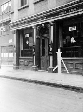 Broad Street (latterly Broadwick Street), Soho, with a white silhouette replica of the Broad Street pump identifed by John Snow as a source of cholera-infected water. Photograph.