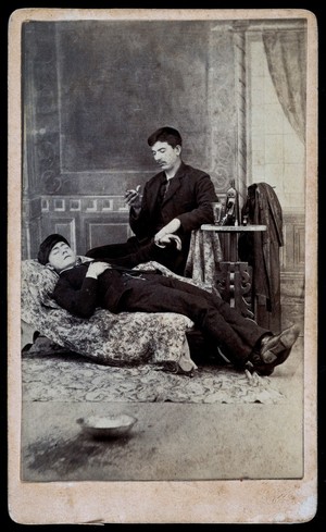 view A man taking the pulse of another man. Albumen print.