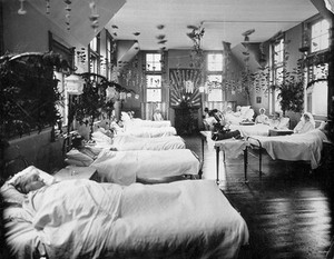 view A women's ward in an unidentified hospital, with elaborate decorations. Photograph.