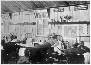 view Imperial Yeomanry Hospital, Deelfontein, South Africa: the "Eastern Counties" ward with patients in bed. Photograph by Sherborn.