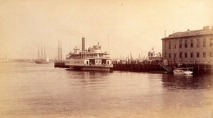 view Bellevue Hospital, New York City: a quay on the East River near the hospital, with a steamship. Photograph.