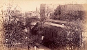 view Bellevue Hospital, New York City: hospital buildings seen from above with the East River on left. Photograph.