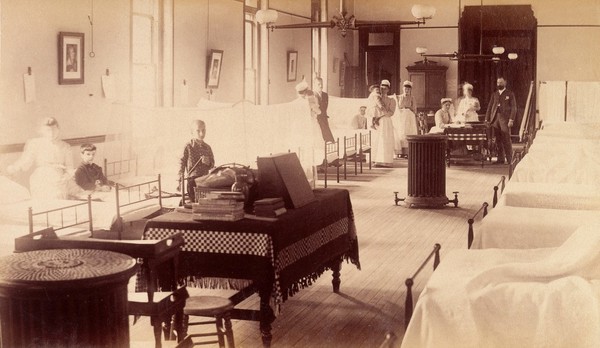 Bellevue Hospital, New York City: a ward for children, protected by bars, with patients, doctors and nurses. Photograph.