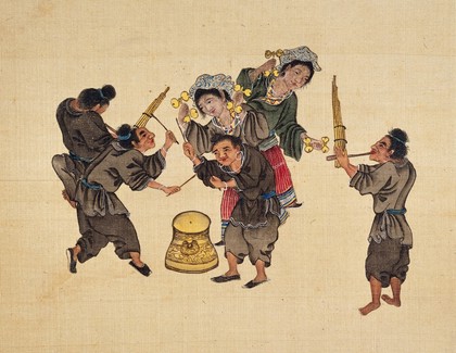 Bulong Miao. A musical scene of the Bulong Miao tribe who belong to the Buyi ethnic group. Two women are dancing while two men play the mouth-organ (sheng) and two others beat a brass drum.