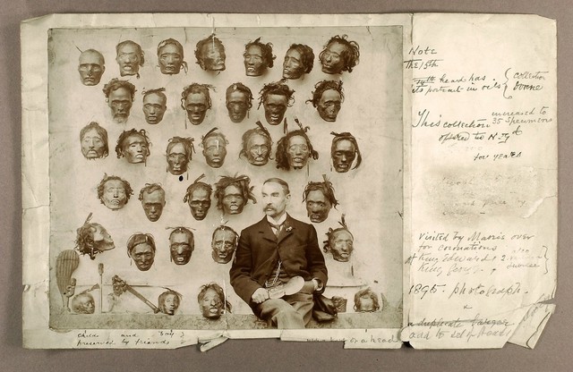 Horatio Robley, seated with his collection of severed heads of Maori people. Photograph by H. Stevens, 190-.