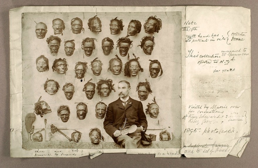 Horatio Robley, seated with his collection of severed heads of Maori people. Photograph by H. Stevens, 190-.
