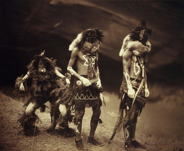 A 'Yebichai Sweat' Navajo medicine ceremony: three Navajos in ceremonial dress with faces masked. Photograph by Edward S. Curtis, 1904.