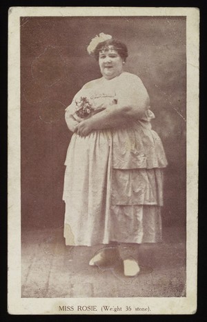 view Miss Rosie (weight 36 stone) holding a bouquet of flowers