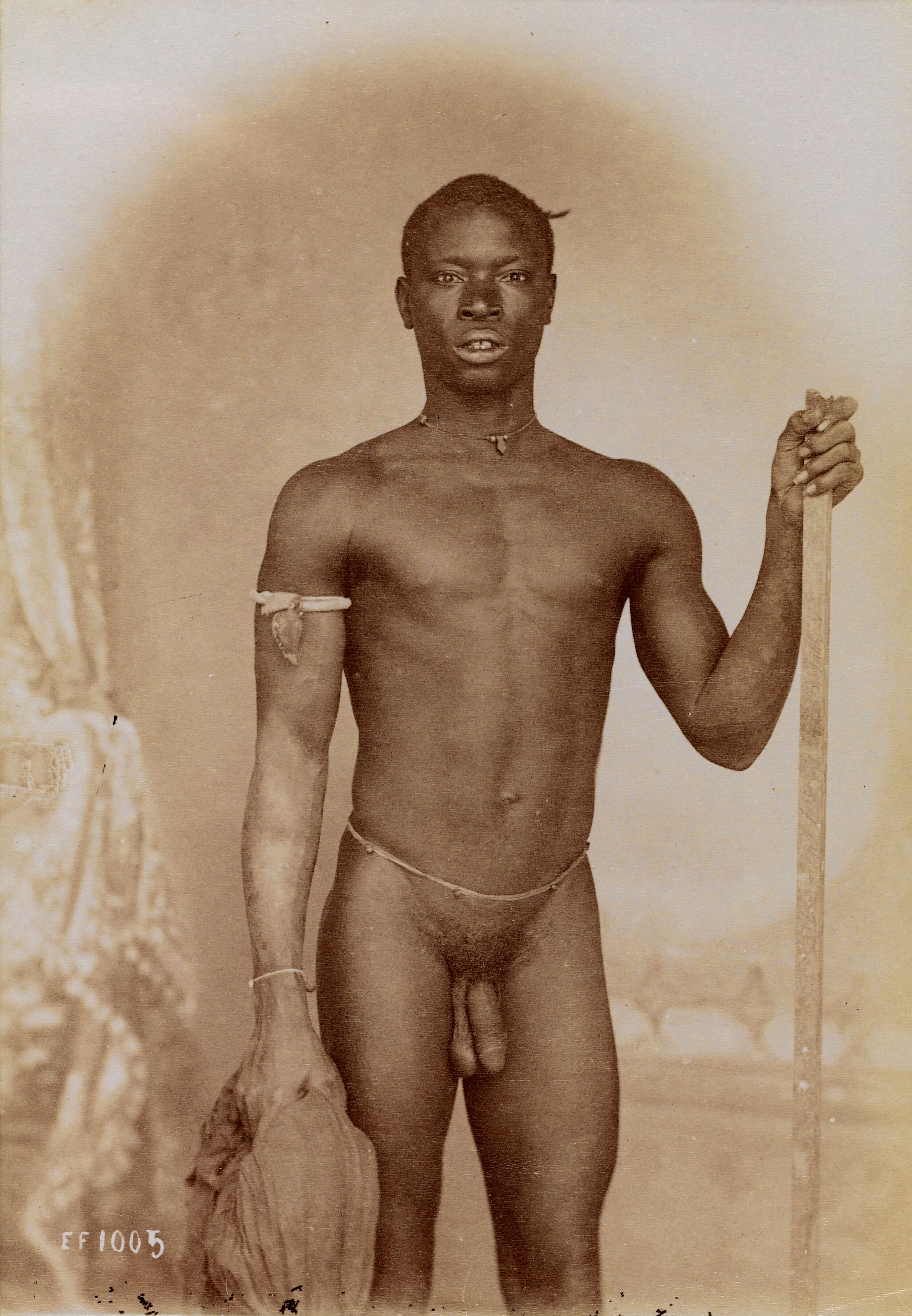 A Young African Man Posing Naked Holding A Stick And A Piece Of Cloth In Front Of A Painted Backdrop Photograph C 1900 Wellcome Collection