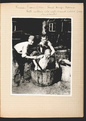 Russian POW being lowered into a bath.