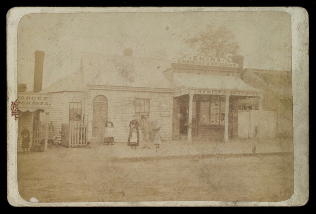 Ekins pharmacy, Melbourne, Victoria: the shop seen from the street, with the pharmacist and his family standing outside. Photograph by E.C. Waddington, ca. 1883/1884.