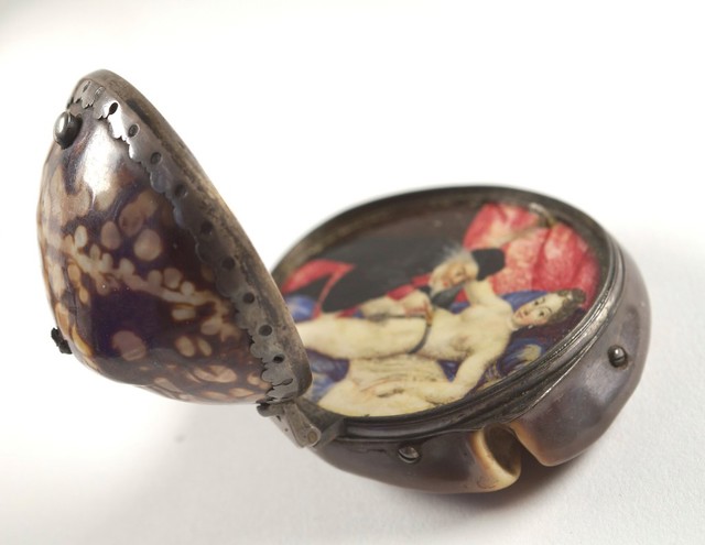 A man unlocking a chastity belt on a woman