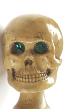 Whalebone walking stick with skull pommel in ivory with green glass eyes, once owned by Charles Darwin