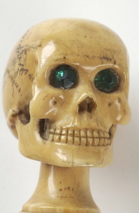 Whalebone walking stick with skull pommel in ivory with green glass eyes, once owned by Charles Darwin