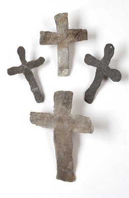 A selection of four lead mortuary crosses, placed on the body of a plague victim, found on the site of the old Grey Friars Monastery, Newgate Street, Lonodn (replicas)