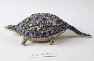 view Sioux Indian amulet in the form of a turtle, worn by girls to ward off illness. Said to contain the umbilical cord of the wearer. Decorated in beading. Northern Plains