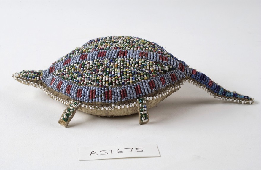 Sioux Indian amulet in the form of a turtle, worn by girls to ward off illness. Said to contain the umbilical cord of the wearer. Decorated in beading. Northern Plains