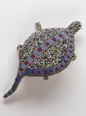 view Sioux Indian amulet in the form of a turtle, worn by girls to ward off illness. Said to contain the umbilical cord of the wearer. Decorated in beading. Northern Plains