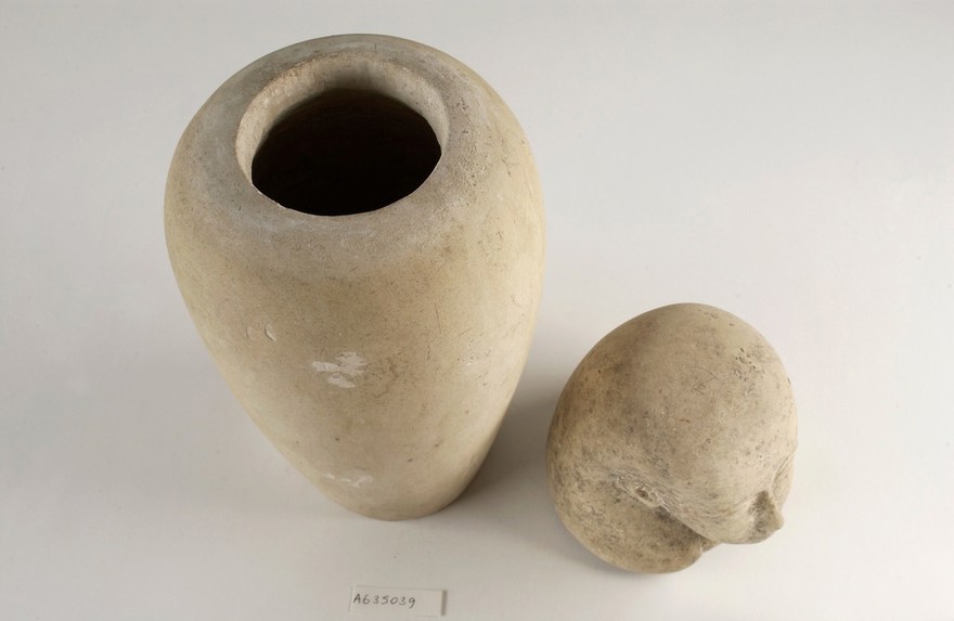 Limestone human headed canopic jar