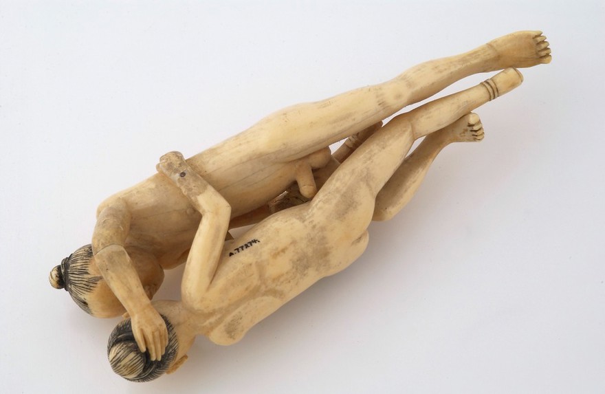 Chinese ivory statue man and woman engaged in sexual foreplay