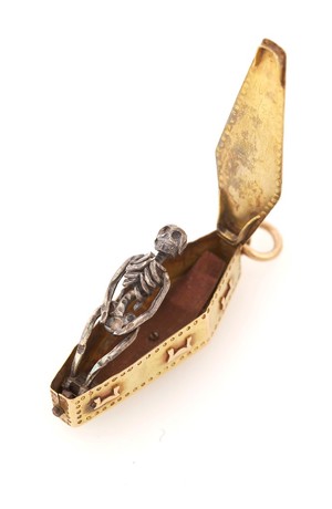 view A gold memento mori pendant, used to remind the user of the transience of life and material luxury, containing a decaying corpse inside a coffin. (Open)