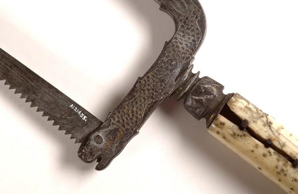 Small bow-frame amputation saw, ornate design on damascened frame, ivory handle, from Hamonic collection.