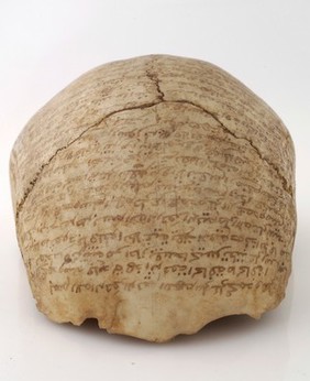 Human skull inscribed with prayers for the deceased. Collected by Robert Baden Powell's Asante (Ghana) expedition 1895