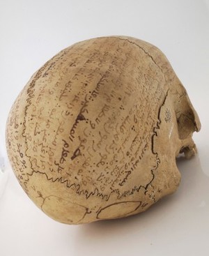 view Human skull inscribed with prayers for the deceased. Collected by Robert Baden Powell's Asante (Ghana) expedition 1895