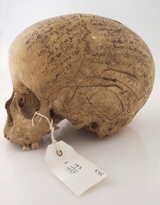 Human skull inscribed with prayers for the deceased. Collected by Robert Baden Powell's Asante (Ghana) expedition 1895
