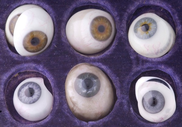 A small case of false eyes, white glass, with blood vessels in red, and vari-coloured lenses. Made by W. Halford of London.