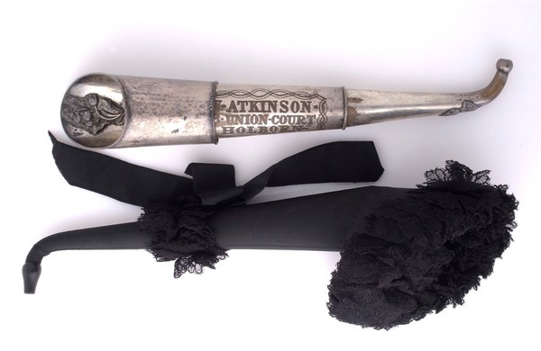 Two Victorian ear trumpets, one made of tin made by Atkinson, Union Court, Holborn, London, and the other swathed in black silk and lace mourning