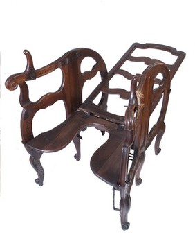 A foldable and adjustable birthing chair, made of walnut wood. European