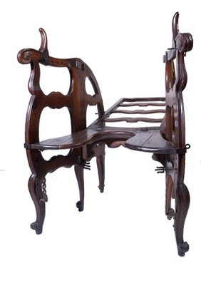 A foldable and adjustable birthing chair, made of walnut wood. European