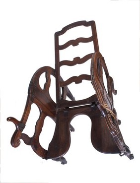 A foldable and adjustable birthing chair, made of walnut wood. European