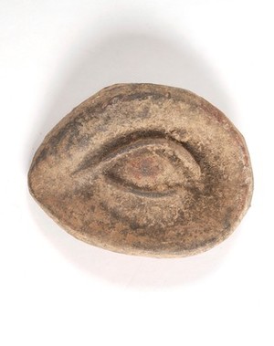 view A clay-baked eye. Roman votive offering