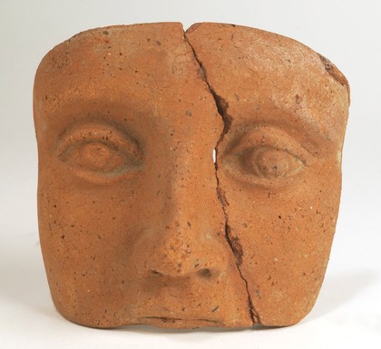 A clay-backed face. Roman votive offering