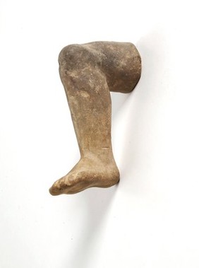 A clay-backed leg and foot. Roman votive offering