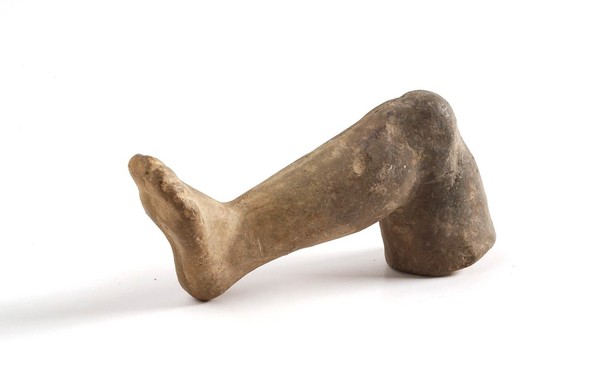 A clay-backed leg and foot. Roman votive offering