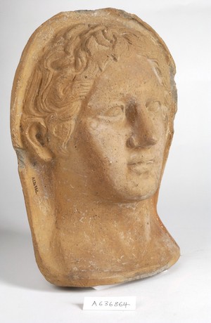 view A clay-baked face. Roman votive offering