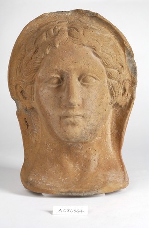 view A clay-baked face. Roman votive offering