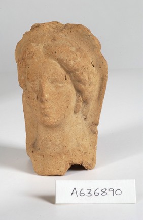 A clay-baked face. Roman votive offering