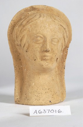 A clay-baked face. Roman votive offering