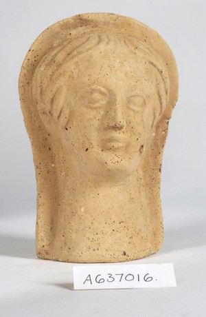 view A clay-baked face. Roman votive offering